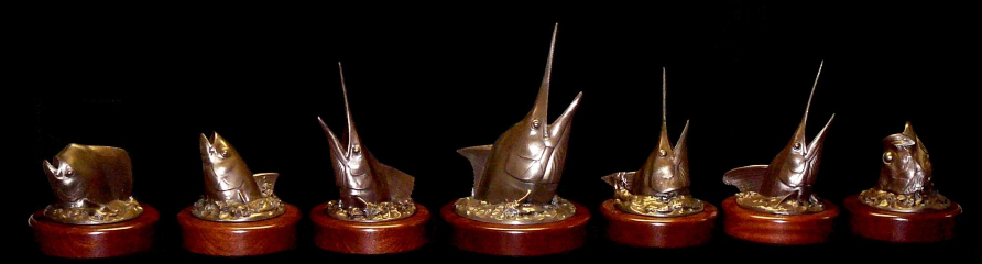 bronze head mount trophies on rotating mahogany bases
